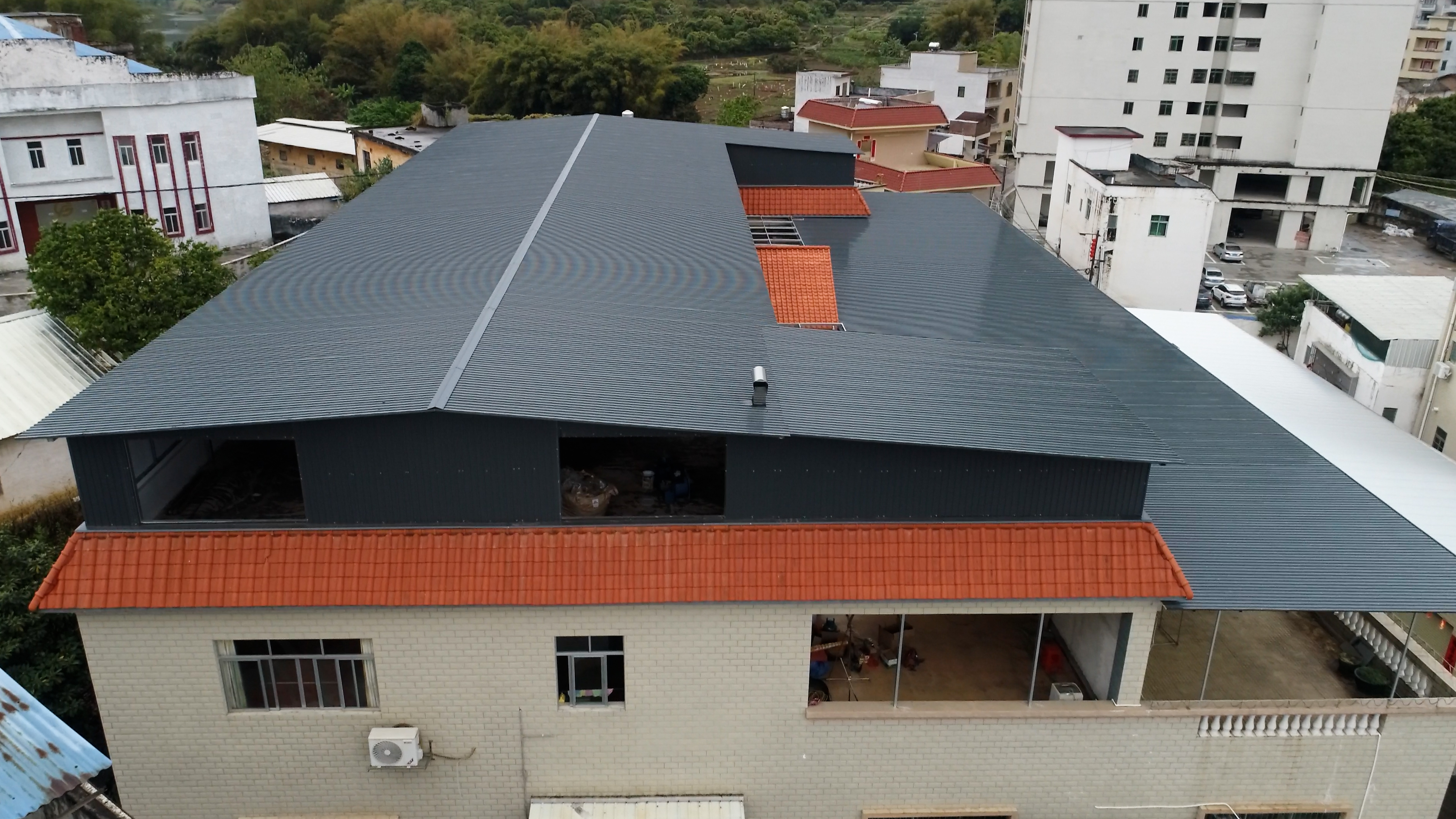 The factory located in Guangdong uses modern metal roof sandwich panels, coverin